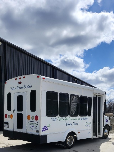 The rear side of a shuttle bus with wine decorations